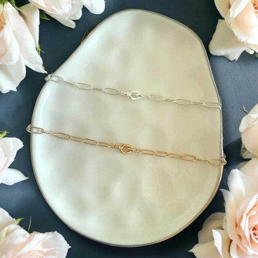 Coastal Love Knot Bracelet in silver and gold tones, featuring slender paperclip chains and small love knot charms