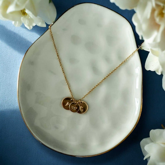 Stamped Story Necklace with a fine gold-tone chain and three small round hand-stamped charms, including a heart